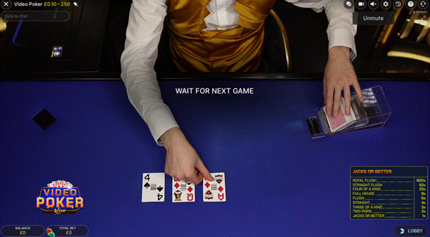 Evolution Live Video Poker showing a blue table and the live dealer in the process of dealing the cards